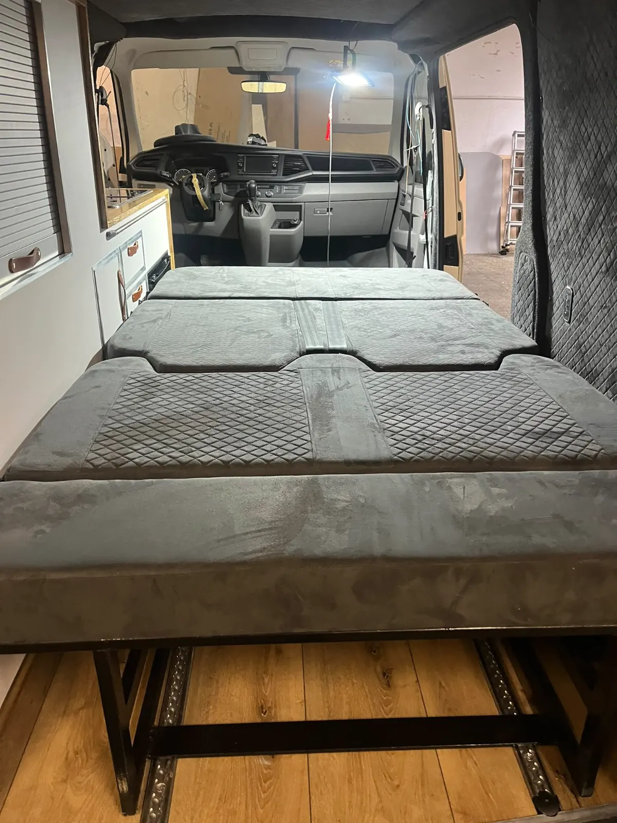 Upholstered bedroom in a camper van