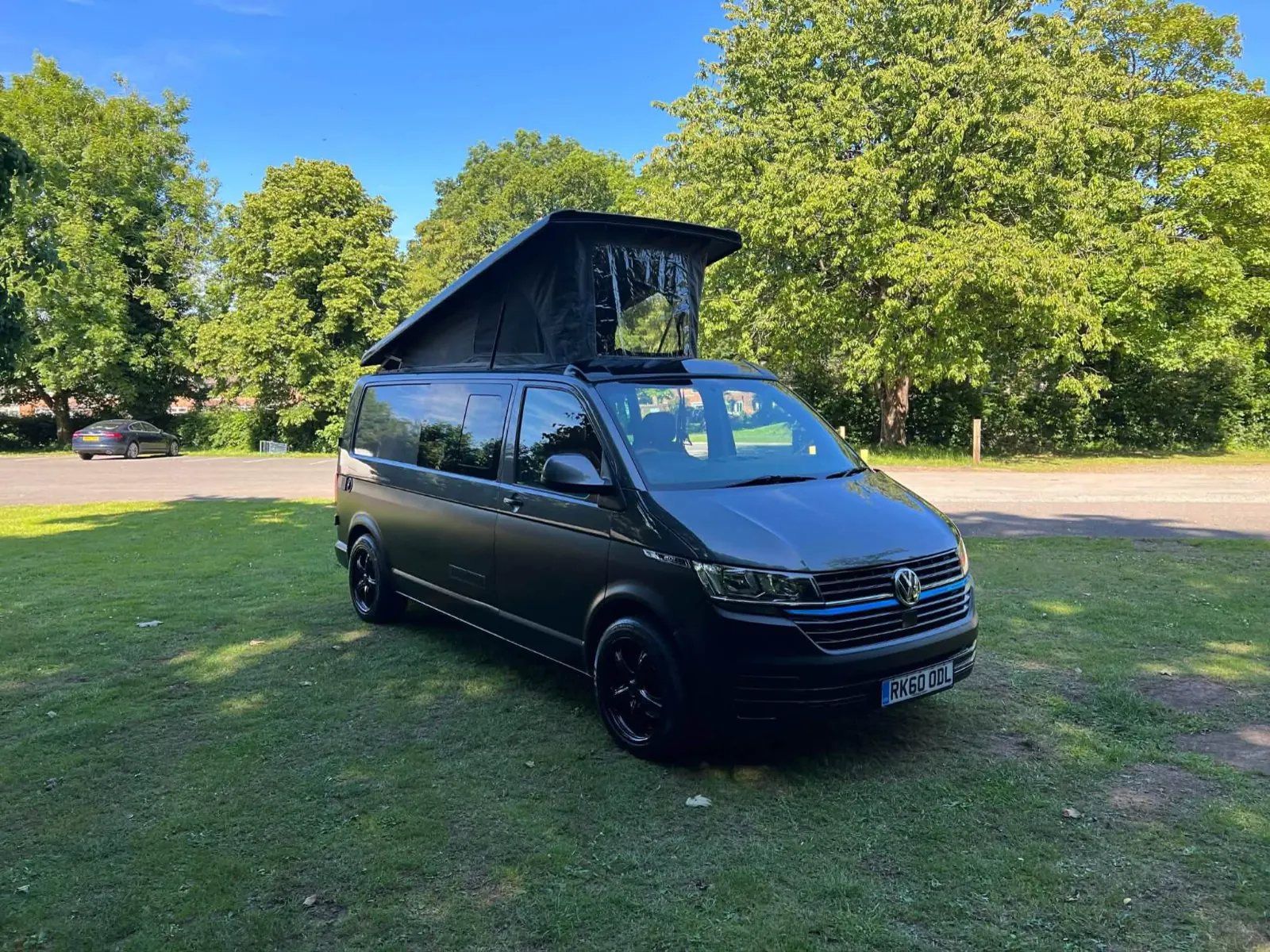 VW T6 with a pop-up roof in a forest