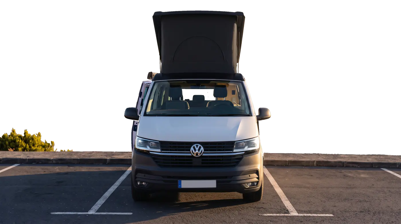 Camper van parked above a sea of clouds at sunrise